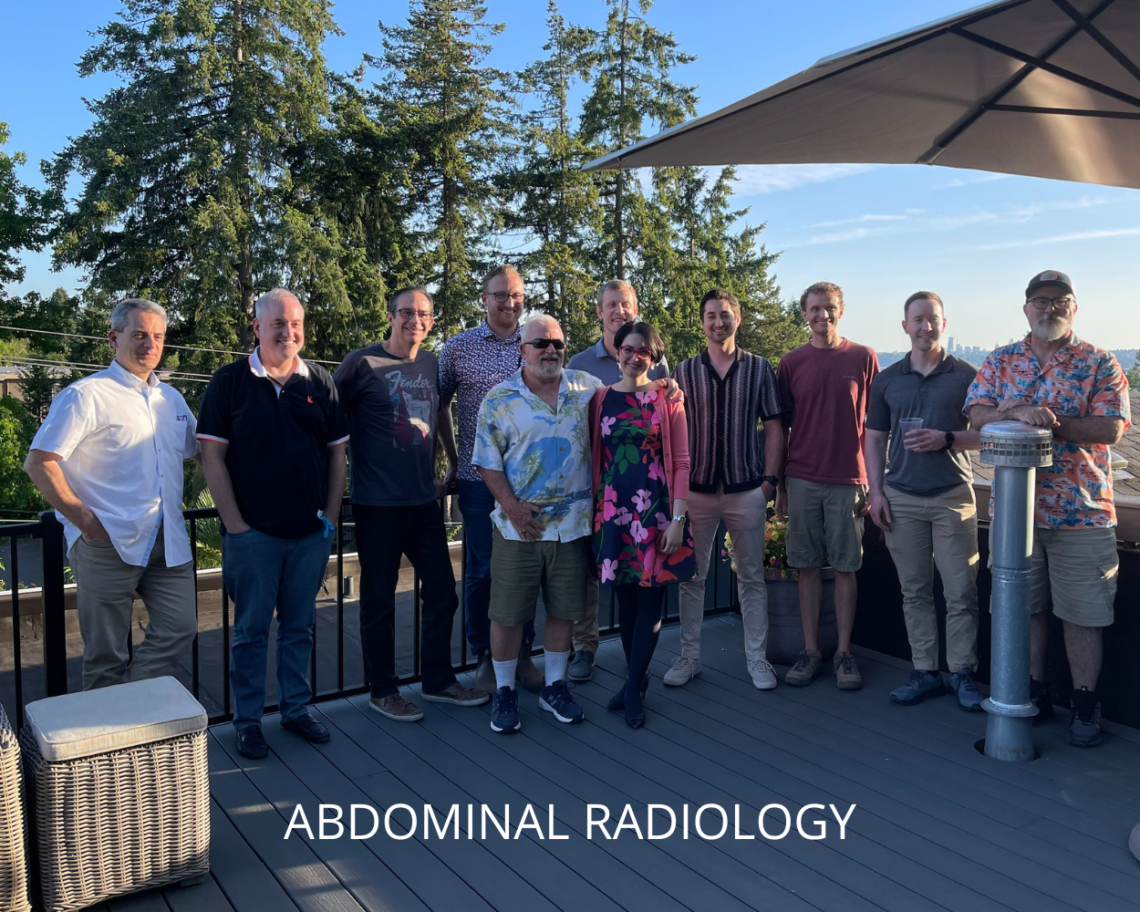 A group photo of the abdominal radiology graduates and team. The group members stand on a deck in a natural setting with an umbrella providing shade. Text reads: abdominal radiology.