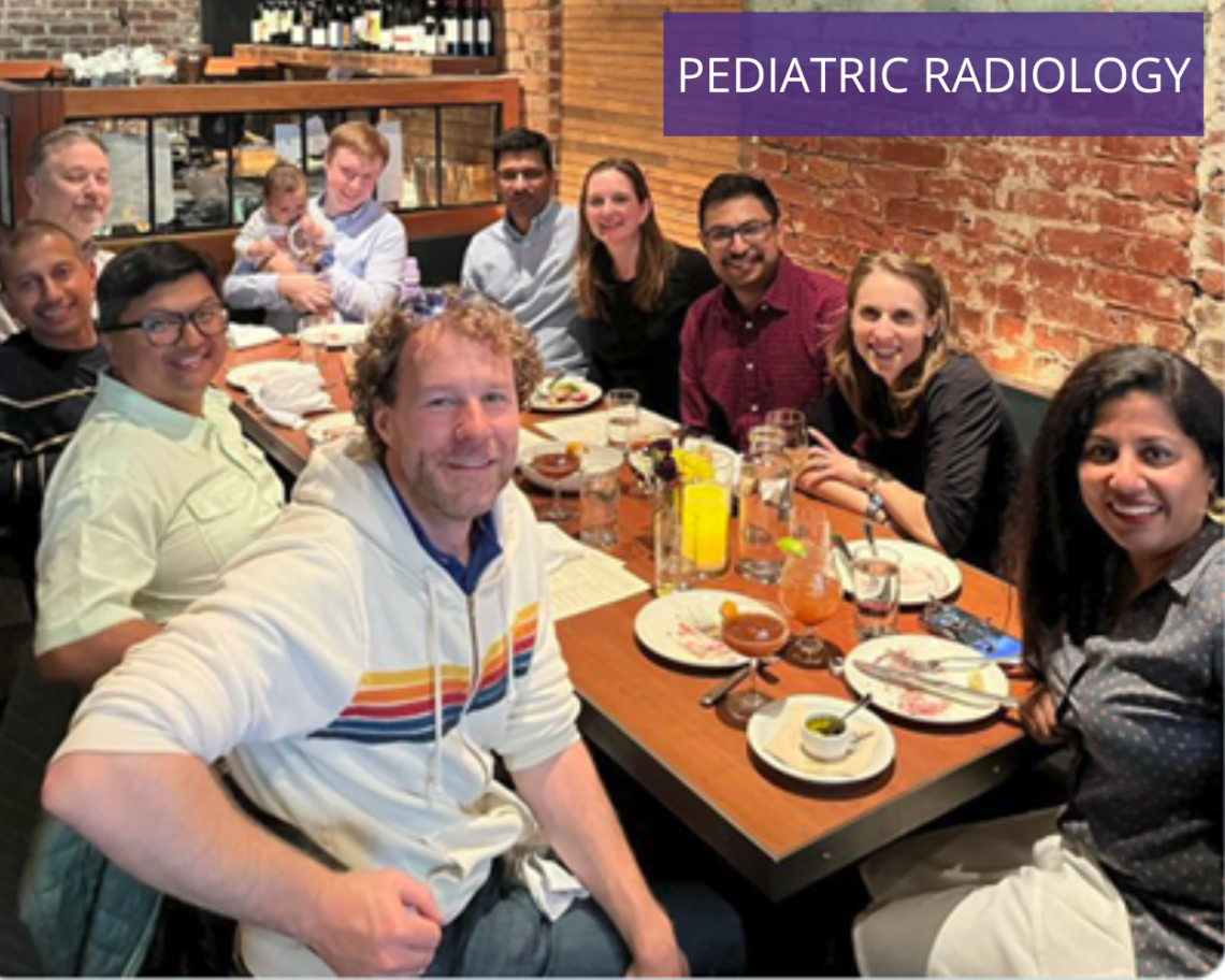 A photo of the pediatric radiology graduates. They gather around a table but look at the camera; a brick wall is behind them. Text reads: pediatric radiology.