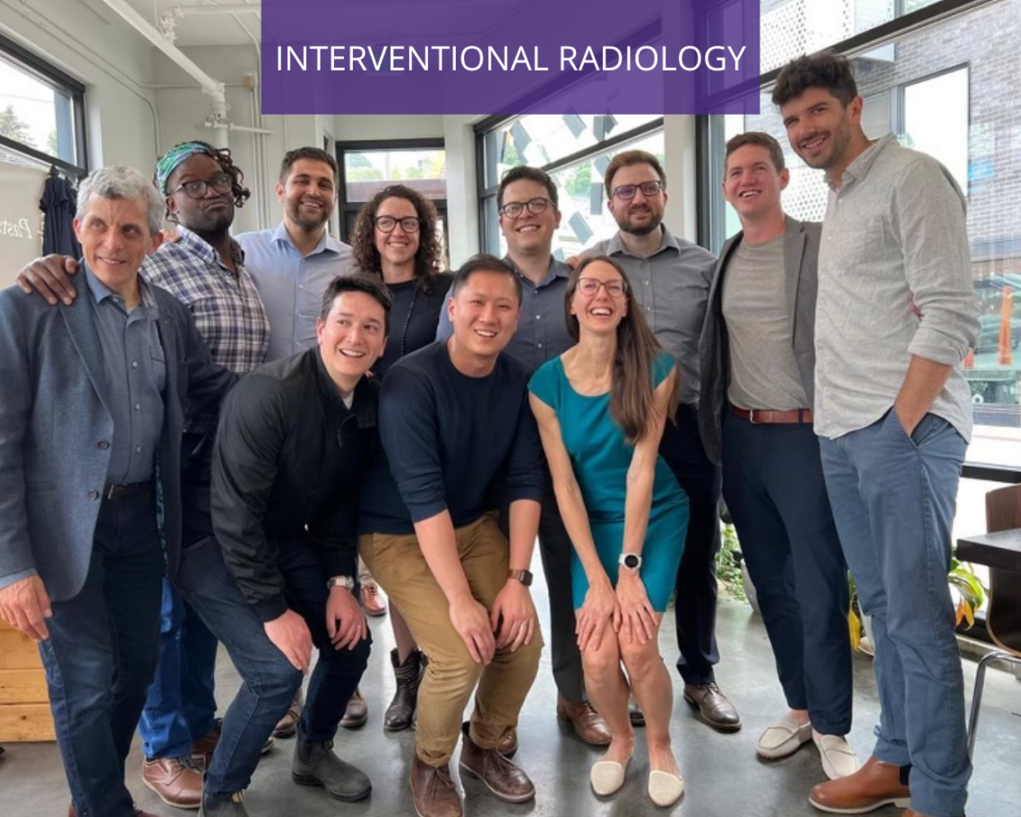 The interventional radiology graduates pose together for a group shot. They stand in a well-lit room next to one another. The text reads: interventional radiology.