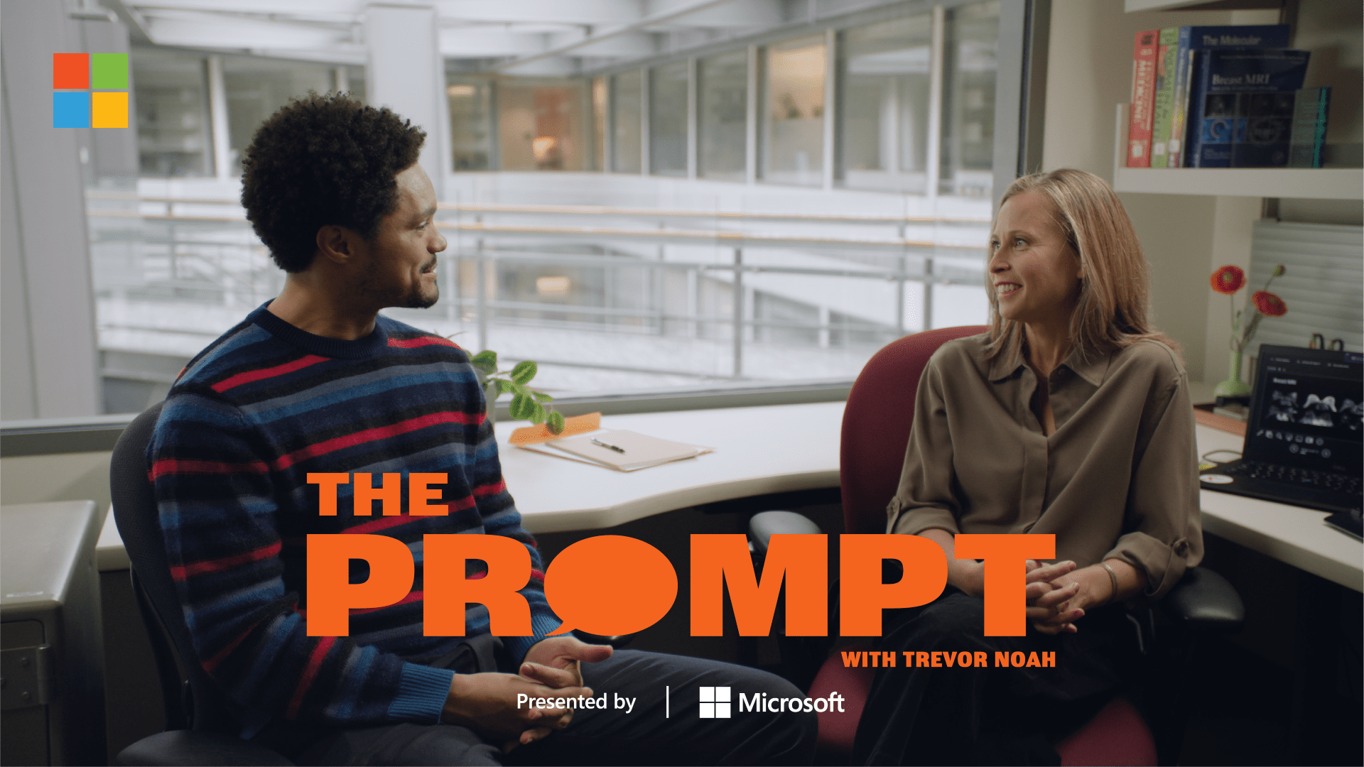 A screenshot of Trevor Noah and Dr. Savannah Partridge sitting in an office space. The text reads: The Prompt with Trevor Noah presented by Microsoft.