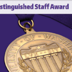 A gold medal embossed with the words: University of Washington on a purple background. Text at the top reads: Distinguished Staff Award.