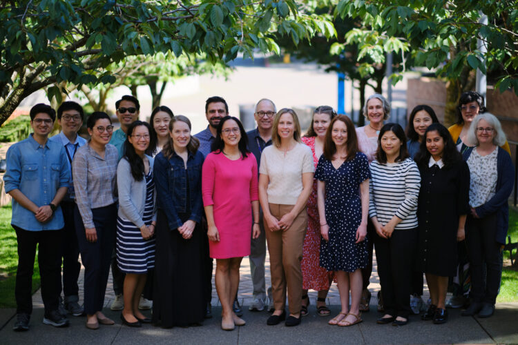 A group of people, assembled and smiling at the camera. 